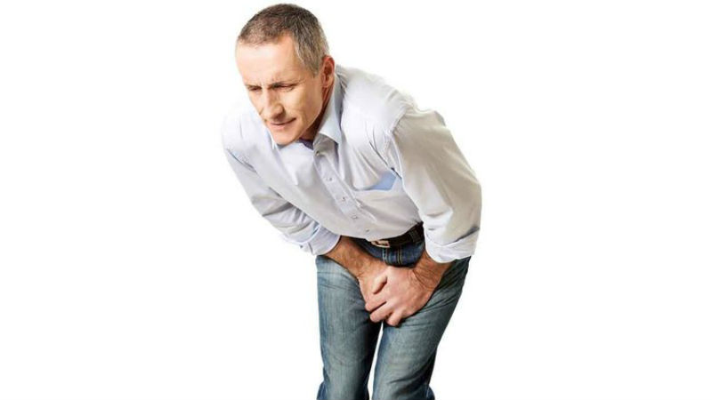 Man grips his groin in pain after learning of male sports hernia symptoms