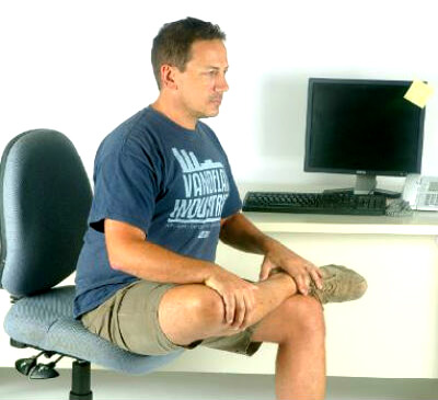 seated hip stretch done just prior to performing psoas muscle pain exercises for lasting relief