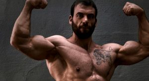 ben pollack, one of the strongest and most elite lifters to use powerlifting program for mass, performing a front double bicep pose