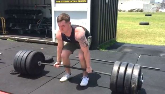 Novice lifter completing deadlifts during the initial stages of a beginner powerlifting program