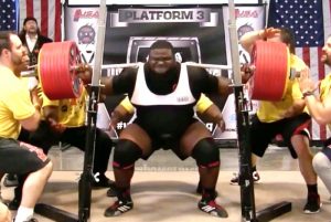 Elite strength athlete Ray Williams Squats 1,005 pounds to set a new world record while wearing red and black SBD powerlifting knee sleeves
