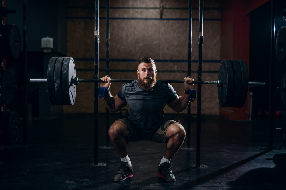 Powerlifter performs squats as part of the Madcow 5x5 Workout on Monday