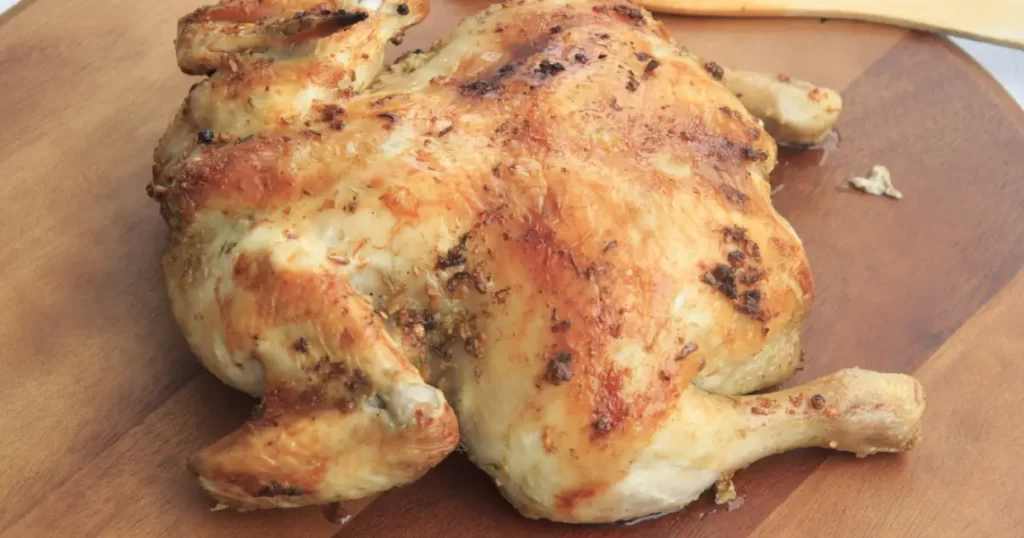 A rotisserie chicken with both white meat or chicken breast and dark meat or chicken legs.