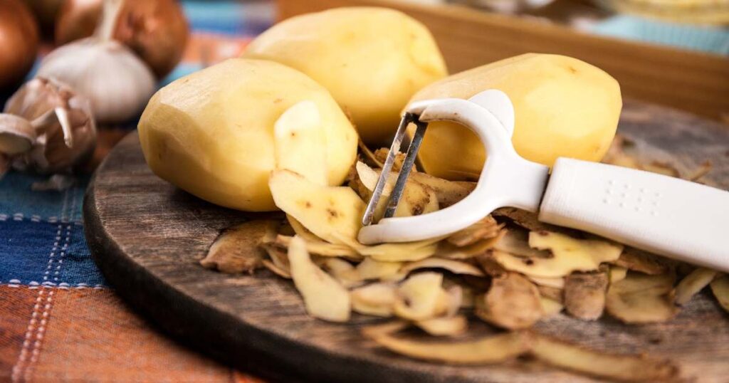 Potato and potato skin being mashed together for a healthy mashed potato dish. 