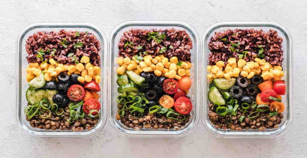 3 Tupperware dishes with pre-cooked meals within them. 