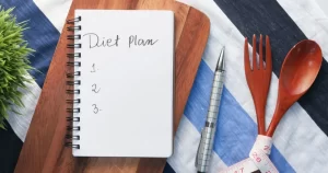 A notebook for someone to write down their diet plan and fasting facts for a healthy weight loss journey.
