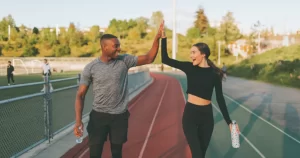Two people high fiving after abandoning fasting myths for a healthy lifestyle.