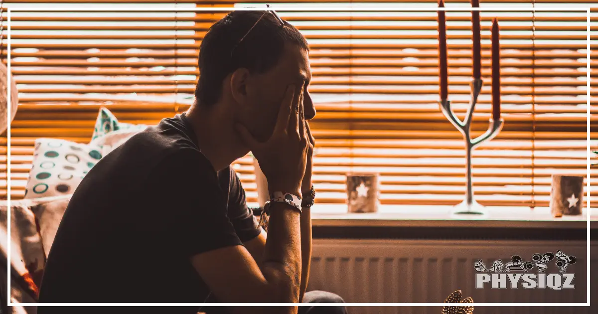 A person looks stressed and sad, questioning why they appear fatter after exercising despite doing everything right, while seated in an orange-tinted room.