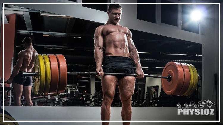 A muscular man wearing only a black short, lifting a barbell, exerting great strength, parts of his muscles are showing and veins popping out, answering his question "where should you feel deadlifts."
