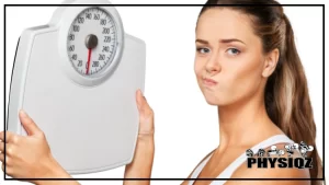 A woman with brown her and a white tank top on looking at a bathroom or bodyweight scale with a face of discontent and frustration because she is attached to the number on the scale and unaware of why the scale doesn't matter.