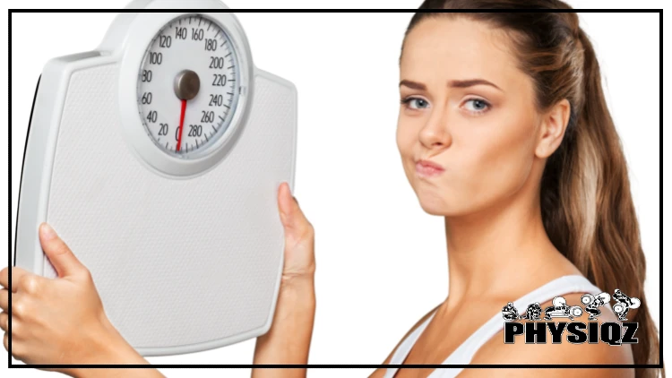 A woman with brown hair, wearing a white tank top, looks at a bathroom scale with a frustrated and discontented expression, unaware of why the number on the scale shouldn't matter.