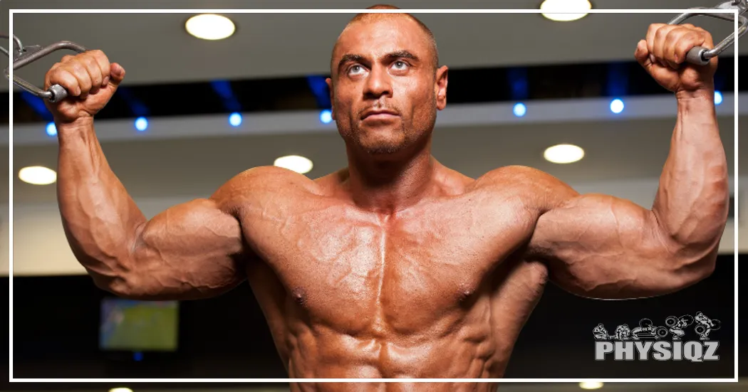 A muscular man grips handles before a cable fly exercise, revealing uneven nipples and asymmetrical chest muscles.