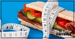 A Oven Roasted Turkey and Ham sandwich with turkey, pickles, cheese and peppers is laying on a blue background with a measuring tape wrapped around it to show it's number 3 in the line up of low calorie subs at subway.