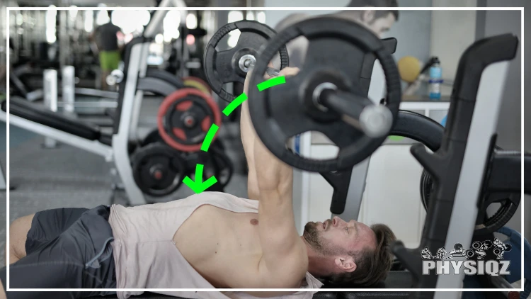 A man in a beige tank top and black shorts is bench pressing with a barbell, accompanied by a green illustration showing the correct "J" shaped bar path.