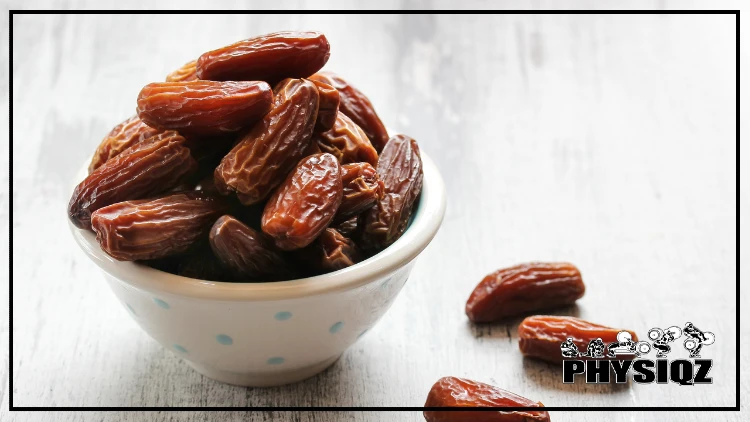 A small bowl of dried dates sits on the table, along with three of them.