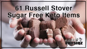 A person wearing a white t-shirt is holding a bunch of Russell Stover sugar free keto treats with both hands.