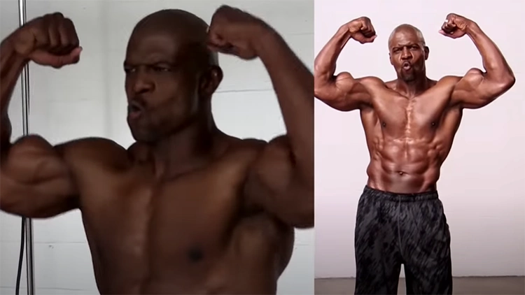 Terry Crews, an African American actor, is standing in the set of a movie or show, topless and flexing both his arms.