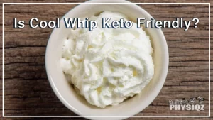 On a wooden surface, there is a small ceramic bowl filled with whipped cream, overlayed with a text that says "is Cool Whip keto friendly?" for dieters who are wondering about the same question.