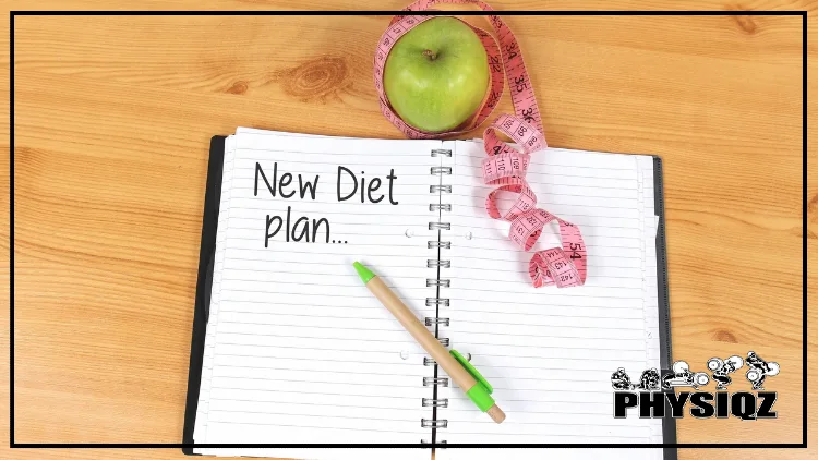 An opened note pad that is on a wooden table reads "New Diet Plan" with a green and beige pen laying on top, and a green apple wrapped in measuring tape beside it. 