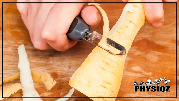 A person is wondering 'is parsnip keto approved?' as they peel a piece of parsnip using a steel peeler on a wooden board.