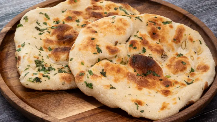 Two pieces of pita flatbreads on a circular wooden board, displayed on top of a wooden surface.