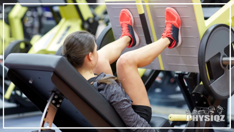 A woman in red shoes has her hair in a bun and her legs at 90 degrees as she does a leg press with one 45lb plate on each side and the leg press machine is yellow. 