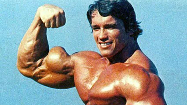 Arnold Schwarzenegger, topless and flexing his bicep that has a high peak on the right.