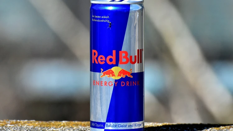 An outdoor photo of a can of red bull energy drink.
