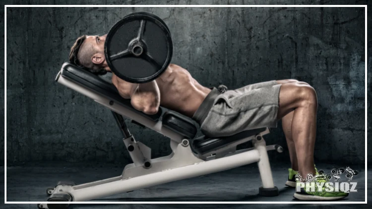 A man without shirt, clad in gray shorts and green shoes, is performing an incline bench press.