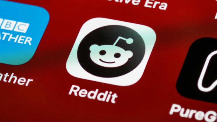 Reddit app icon with a black and white color, the reddit icon is the reddit logo in red background.
