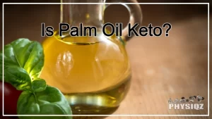 A glass bottle of kitchen oil with green fresh basil leaves and a tomato on the side is placed on a wooden table-like surface, making dieters wonder is palm oil keto or not.