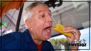 A white old man in blue polo holding a taco and shoveling it to his mouth as he questions if del taco is keto, he is excited to eat the taco and he appears to be at the taco restaurant.