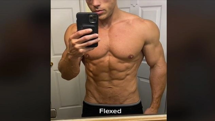 A shirtless man flexing his abs muscles, showing off his toned physique.