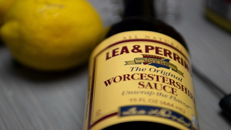 A bottle of Worcestershire sauce, featuring a prominent yellow label with the product name and brand logo.