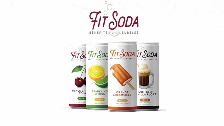 Four cans of Fit Soda that comes in different flavors such as orange creamsicle, sparkling citrus, root bear vanilla float, and black cherry cola displayed on a white surface against a white backdrop.