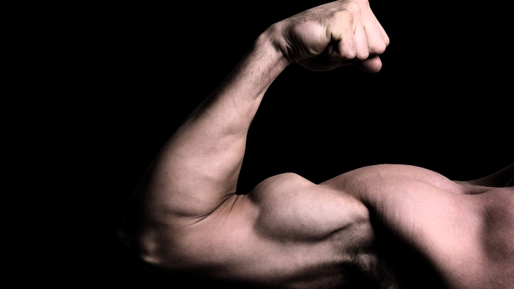 On a black background is a man flexing his biceps muscle.
